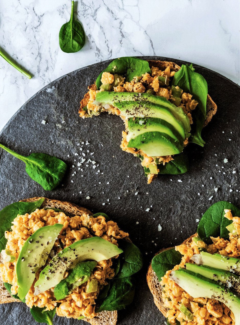 overhead image of chickpea tuna sandwiches on a slate plate.