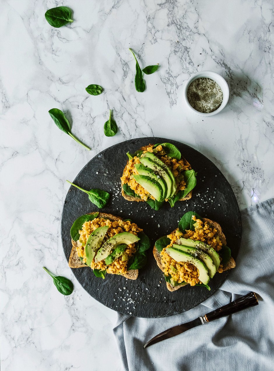 overhead image of chickpea tuna sandwhiches on a white background..