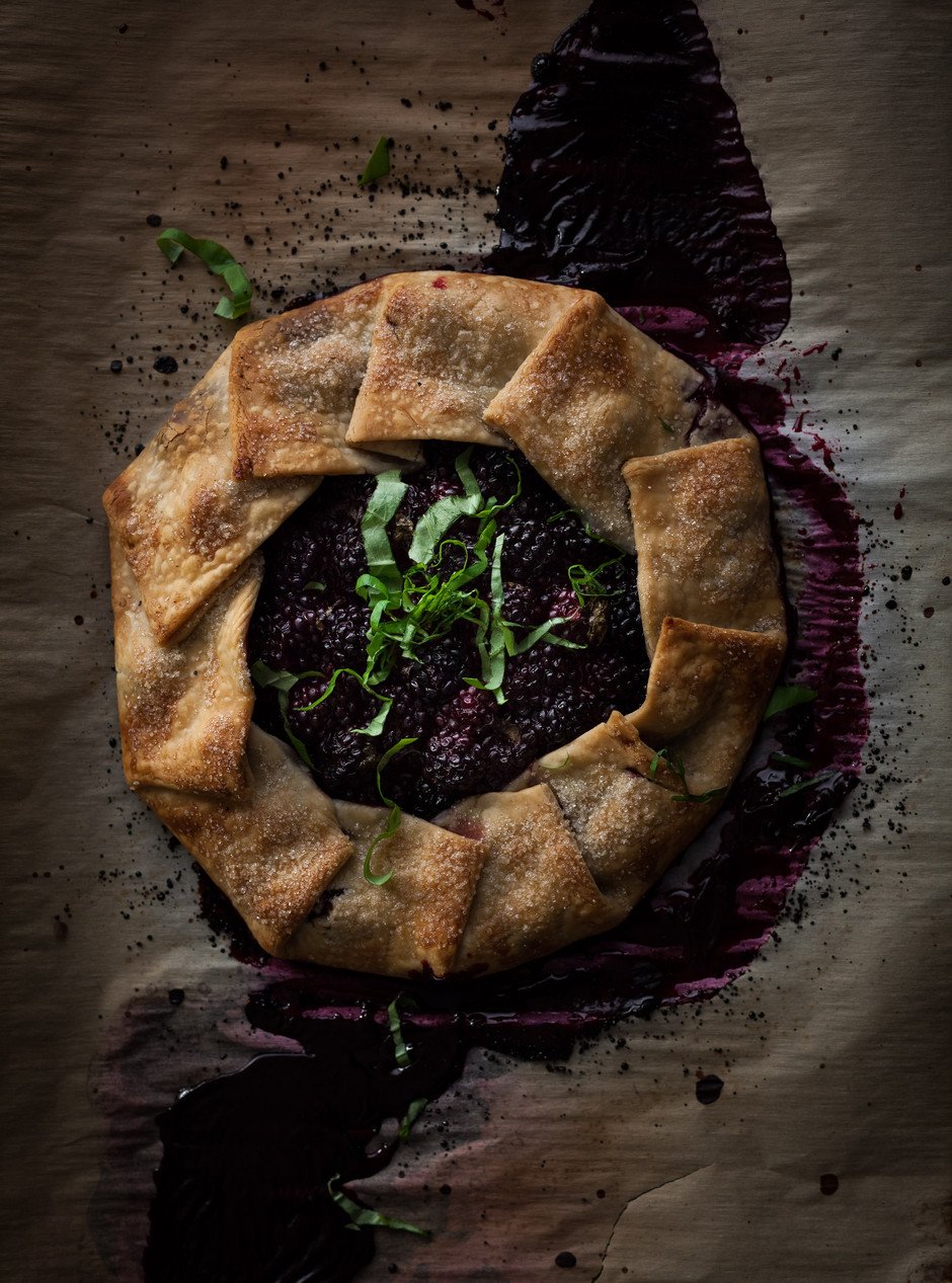 overhead of a blackberry galette on a baking tray.