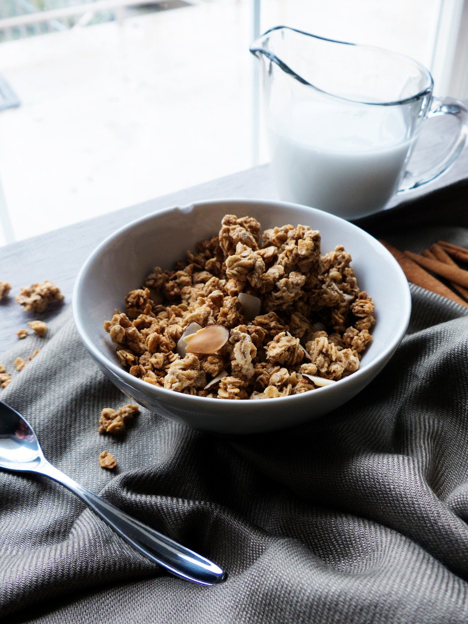A close up ¾ angle image of a bowl of Winter Spice Almond Granola.
