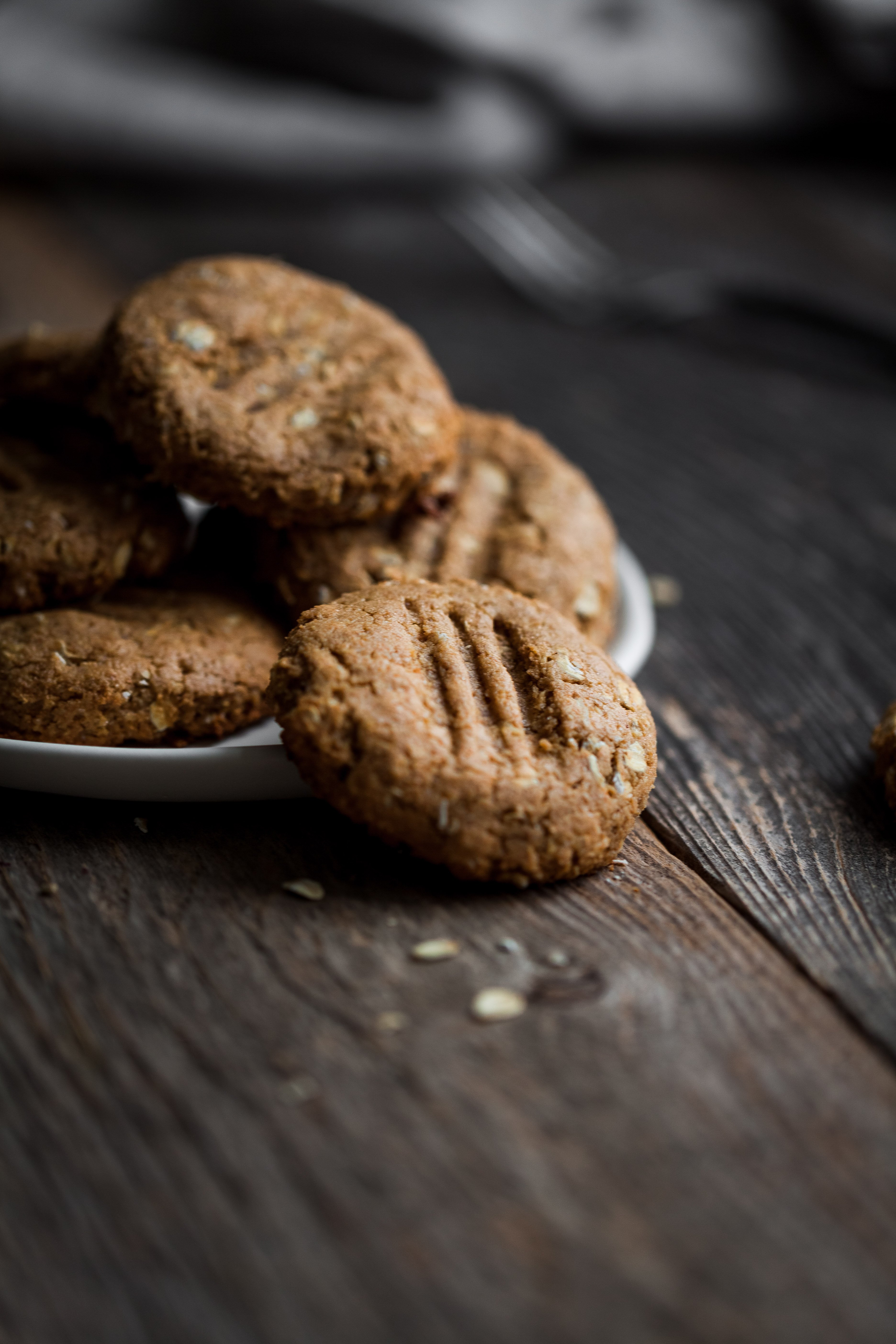 a head on close up of peanut butter cookies on a white plate.
